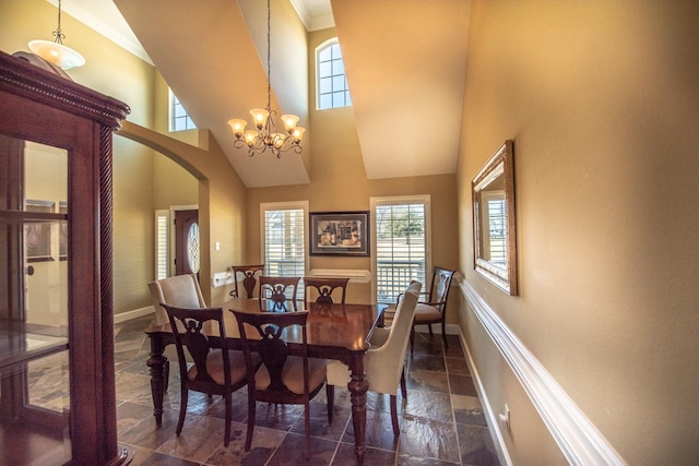 dining area with a chandelier and a high ceiling