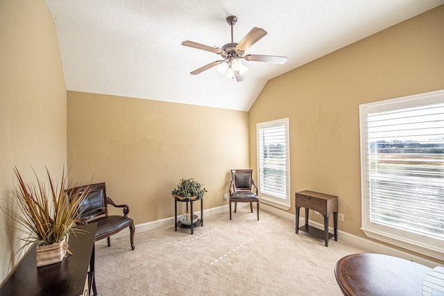 sitting room featuring vaulted ceiling, light colored carpet, and ceiling fan