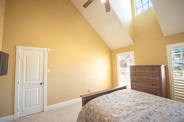 carpeted bedroom featuring ceiling fan and high vaulted ceiling