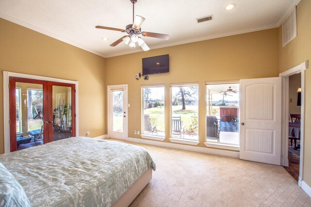 bedroom with crown molding, light colored carpet, french doors, and access to outside