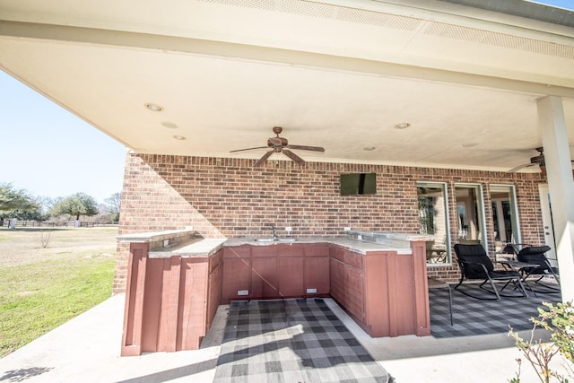 view of patio / terrace with sink and ceiling fan