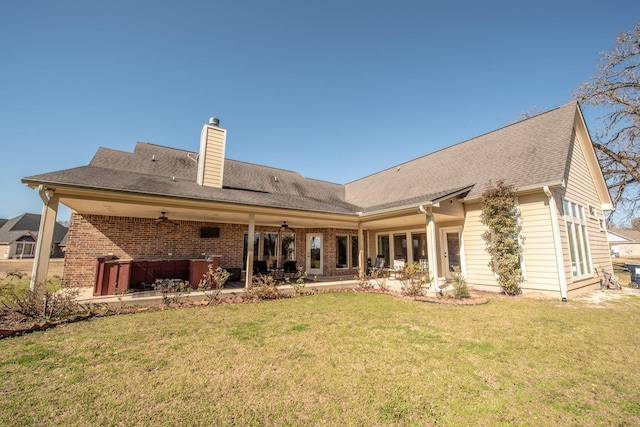 rear view of house with a patio, ceiling fan, and a lawn