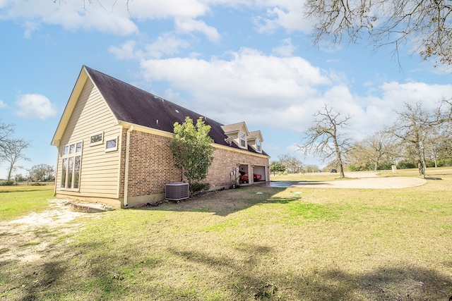 view of home's exterior with a garage and a yard