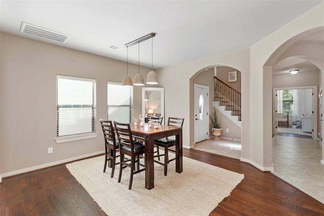 dining space with dark wood-type flooring