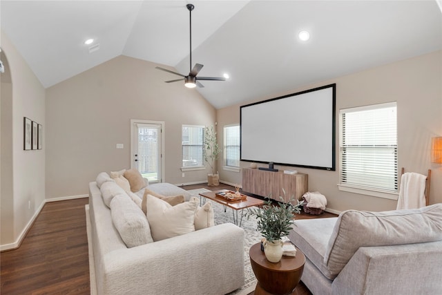 cinema room with dark wood-type flooring, ceiling fan, and vaulted ceiling