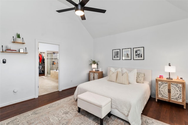 bedroom featuring high vaulted ceiling, hardwood / wood-style flooring, a spacious closet, ceiling fan, and ensuite bath