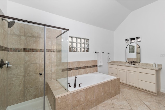 bathroom with tile patterned flooring, vaulted ceiling, vanity, and plus walk in shower