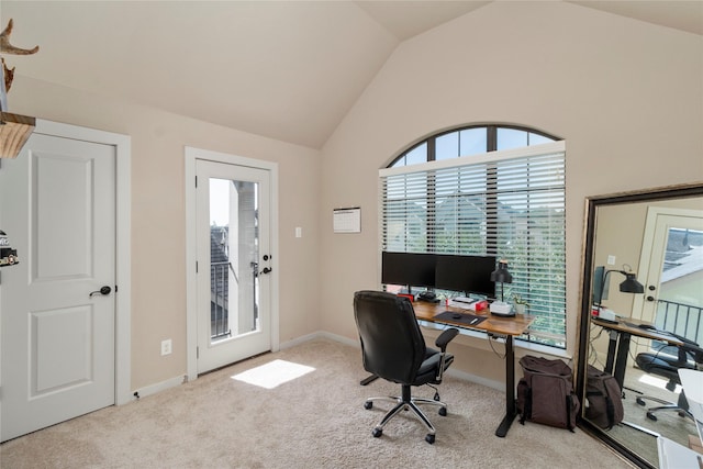 office area with light colored carpet and high vaulted ceiling