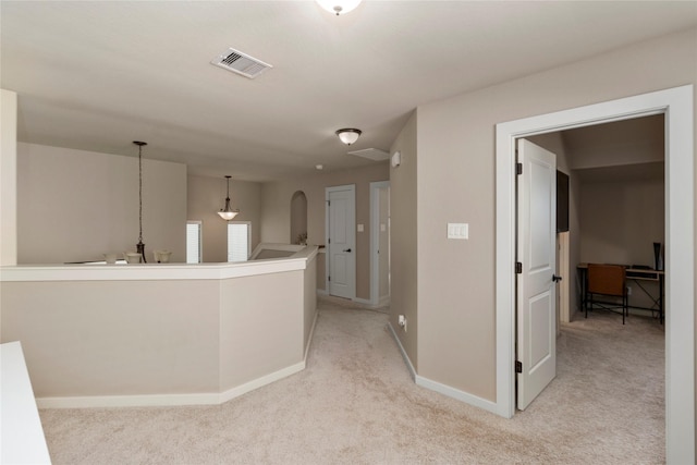 hallway featuring light carpet