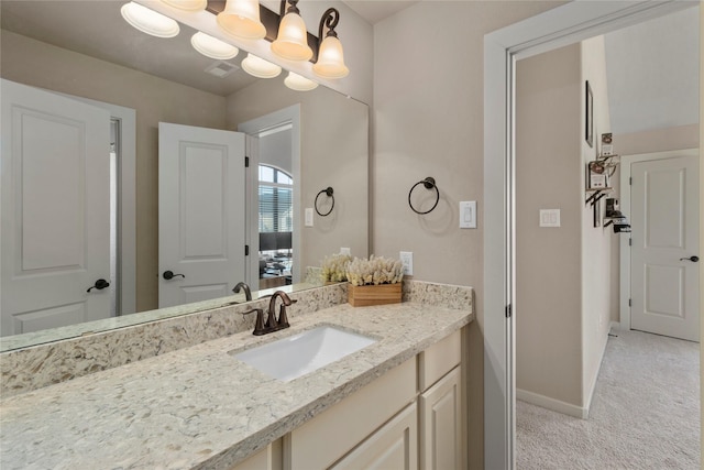 bathroom with an inviting chandelier and vanity