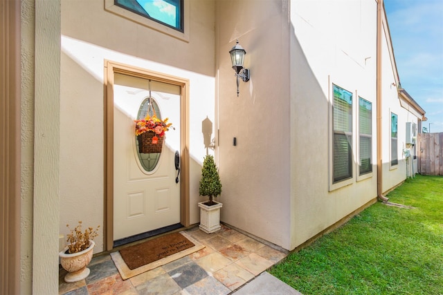 view of exterior entry with stucco siding