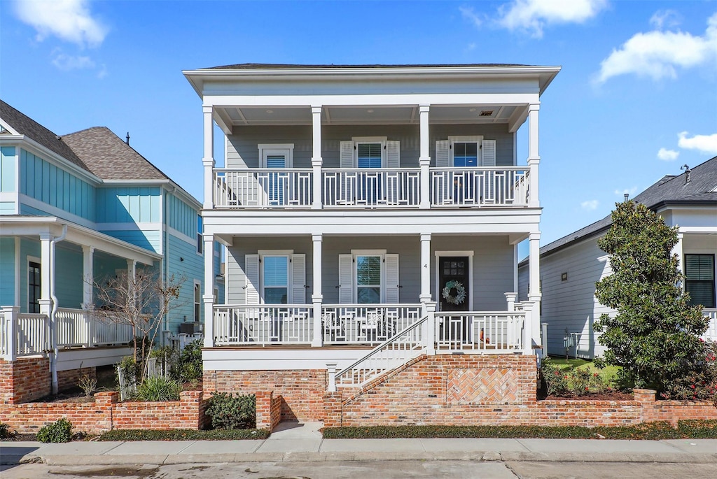 view of front facade featuring a balcony and covered porch