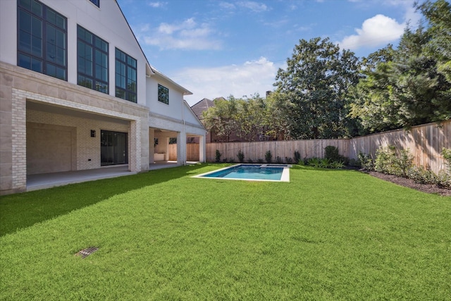 view of yard with a fenced in pool and a patio