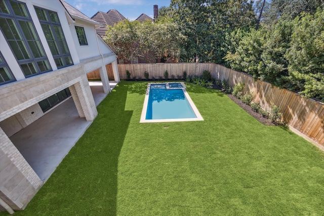 view of pool with a yard