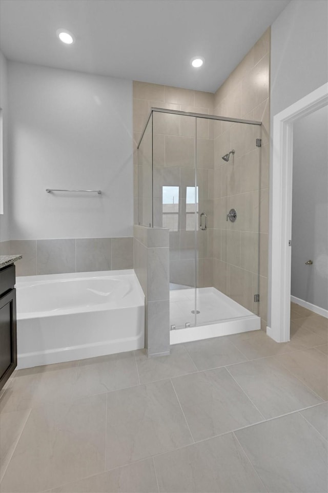 full bath with a stall shower, recessed lighting, a bath, and vanity