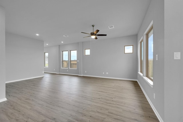 spare room featuring recessed lighting, visible vents, baseboards, and wood finished floors