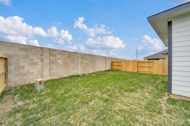 view of yard with a fenced backyard