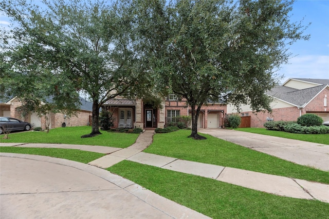 obstructed view of property featuring a garage and a front yard