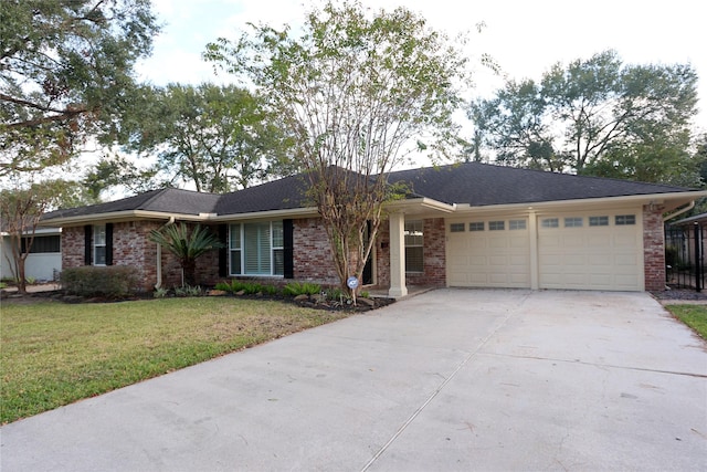 ranch-style house featuring a garage and a front lawn