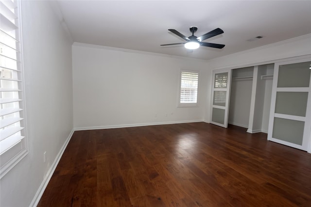 unfurnished bedroom with crown molding, ceiling fan, dark hardwood / wood-style flooring, and a closet