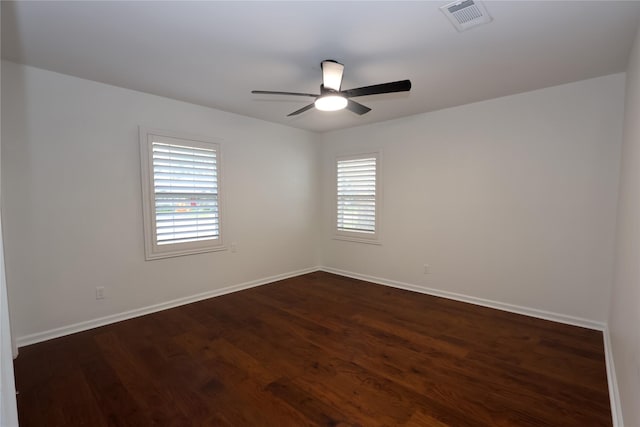 unfurnished room with plenty of natural light, dark hardwood / wood-style floors, and ceiling fan