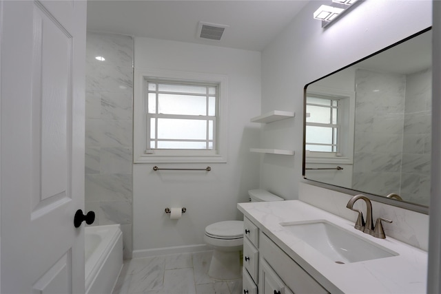 full bathroom with tiled shower / bath, vanity, toilet, and a wealth of natural light