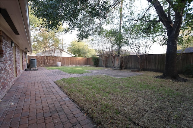 view of yard featuring a patio and central air condition unit