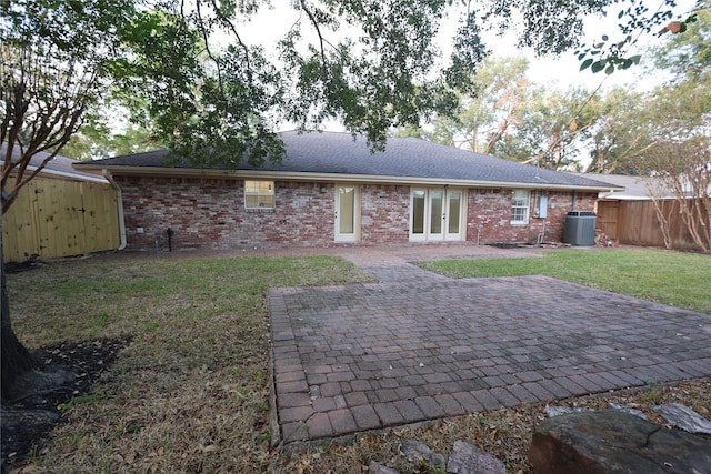 back of house with a patio, central AC, and a lawn