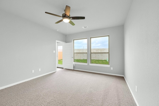 empty room featuring visible vents, baseboards, carpet, and a ceiling fan