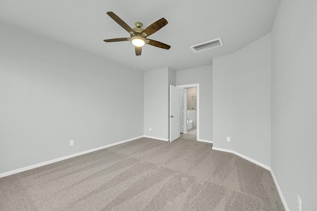 unfurnished bedroom featuring visible vents, ensuite bath, carpet flooring, baseboards, and ceiling fan