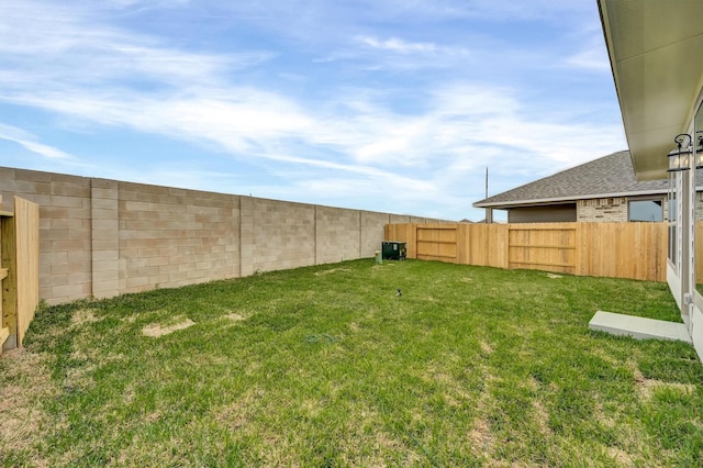 view of yard with a fenced backyard