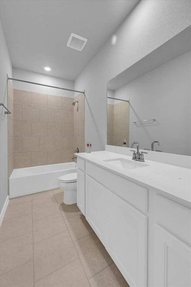 full bath featuring tile patterned flooring, visible vents, washtub / shower combination, toilet, and vanity