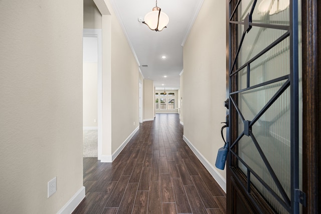 hall featuring recessed lighting, crown molding, baseboards, and wood finished floors