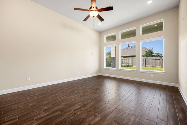 unfurnished room featuring a ceiling fan, recessed lighting, dark wood-style flooring, and baseboards