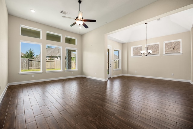 unfurnished living room featuring ceiling fan with notable chandelier, dark wood-type flooring, visible vents, and baseboards