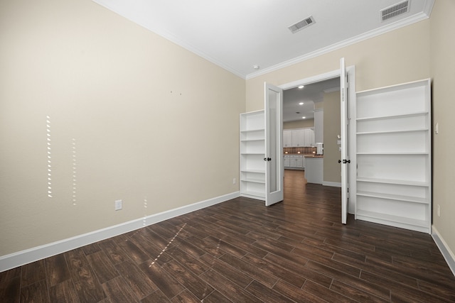 unfurnished bedroom with dark wood-style floors, visible vents, ornamental molding, and baseboards