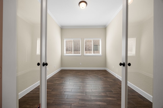 unfurnished room with dark wood-type flooring, french doors, crown molding, and baseboards