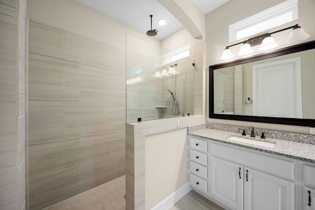 bathroom with a walk in shower and vanity