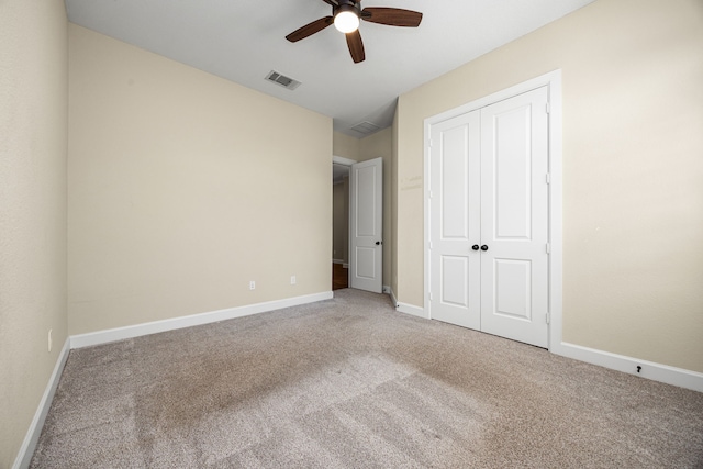 unfurnished bedroom with baseboards, visible vents, ceiling fan, carpet, and a closet