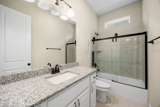 full bath featuring enclosed tub / shower combo, vanity, toilet, and tile patterned floors