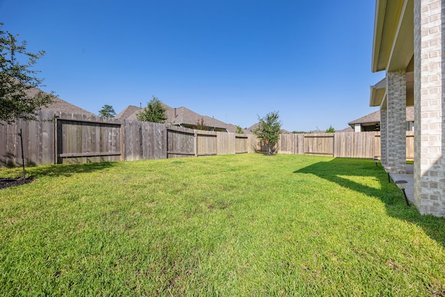 view of yard with a fenced backyard