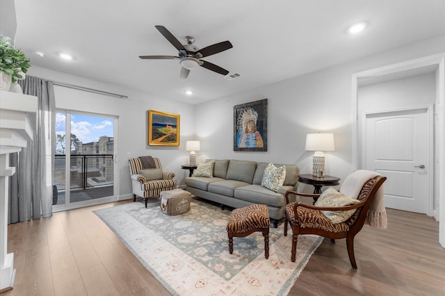 living area featuring a ceiling fan, wood finished floors, visible vents, and recessed lighting