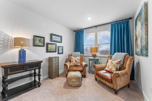 sitting room featuring carpet flooring and baseboards