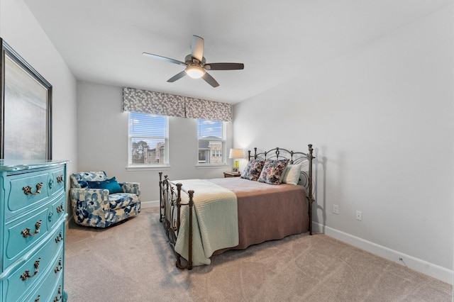 carpeted bedroom featuring ceiling fan and baseboards