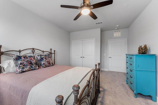 bedroom with light carpet, ceiling fan, a closet, and visible vents