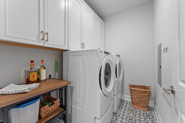 clothes washing area featuring cabinet space, tile patterned flooring, baseboards, and washing machine and clothes dryer