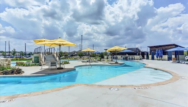 view of swimming pool with a patio