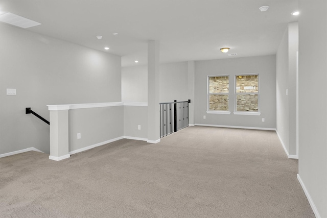 carpeted empty room featuring recessed lighting and baseboards