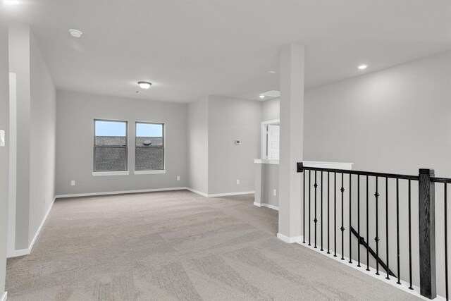 unfurnished room with recessed lighting, baseboards, and carpet flooring