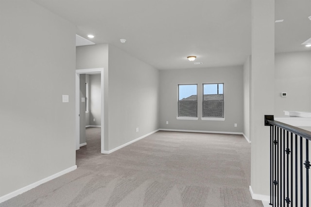 carpeted spare room with recessed lighting and baseboards